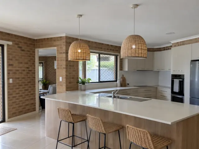 Two woven pendant lights over a kitchen island in a brick-walled home interior in Mermaid Waters